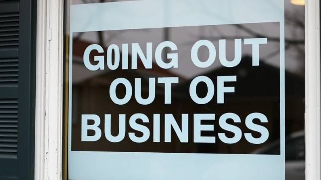 Home service business with a 'going out of business' sign in the window